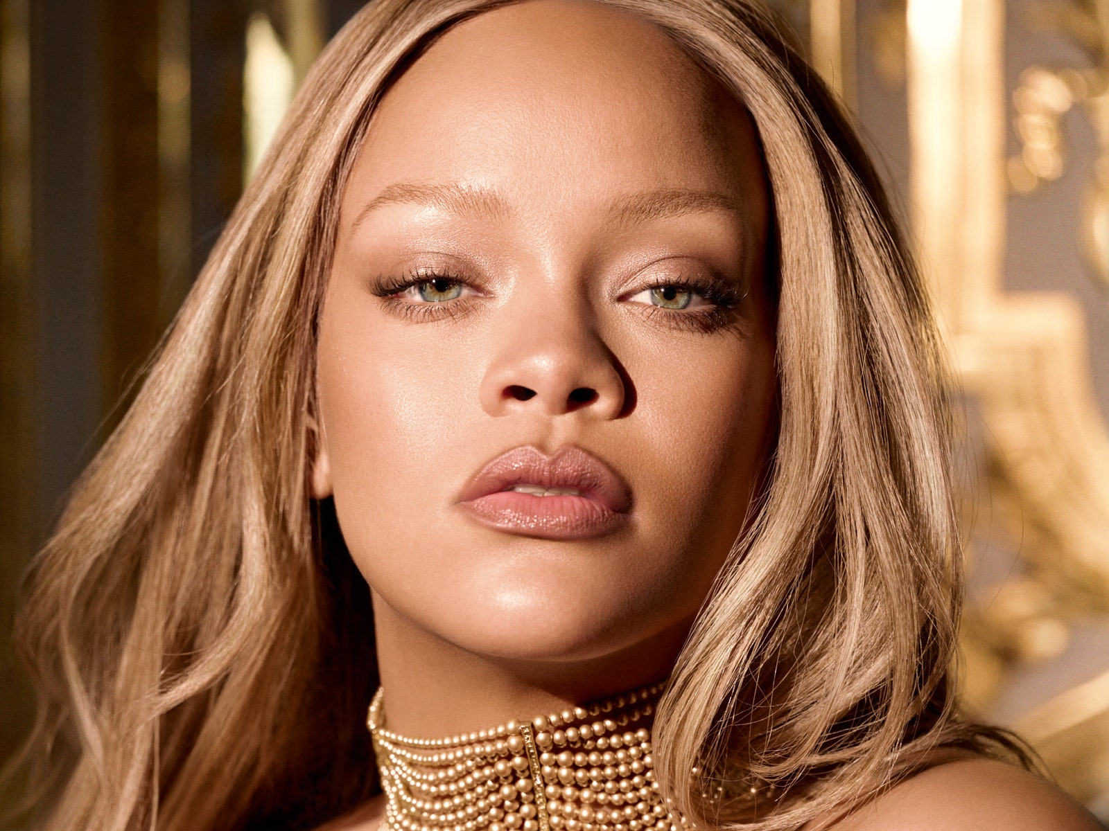 Rihanna embodies the iconic J'adore Dior perfume bottle in a golden corset dress